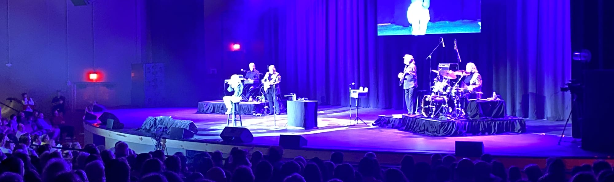 signer on stage in chair washed out by the lights Cleveland